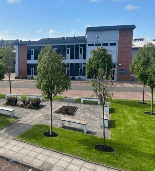 A lovely striped mowed grass area in the middle of an business centre in a business industrial estate